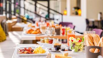 Un bufé de desayuno con diversas opciones de comida y bebidas.