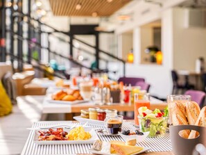 A breakfast buffet with various food items and beverages.