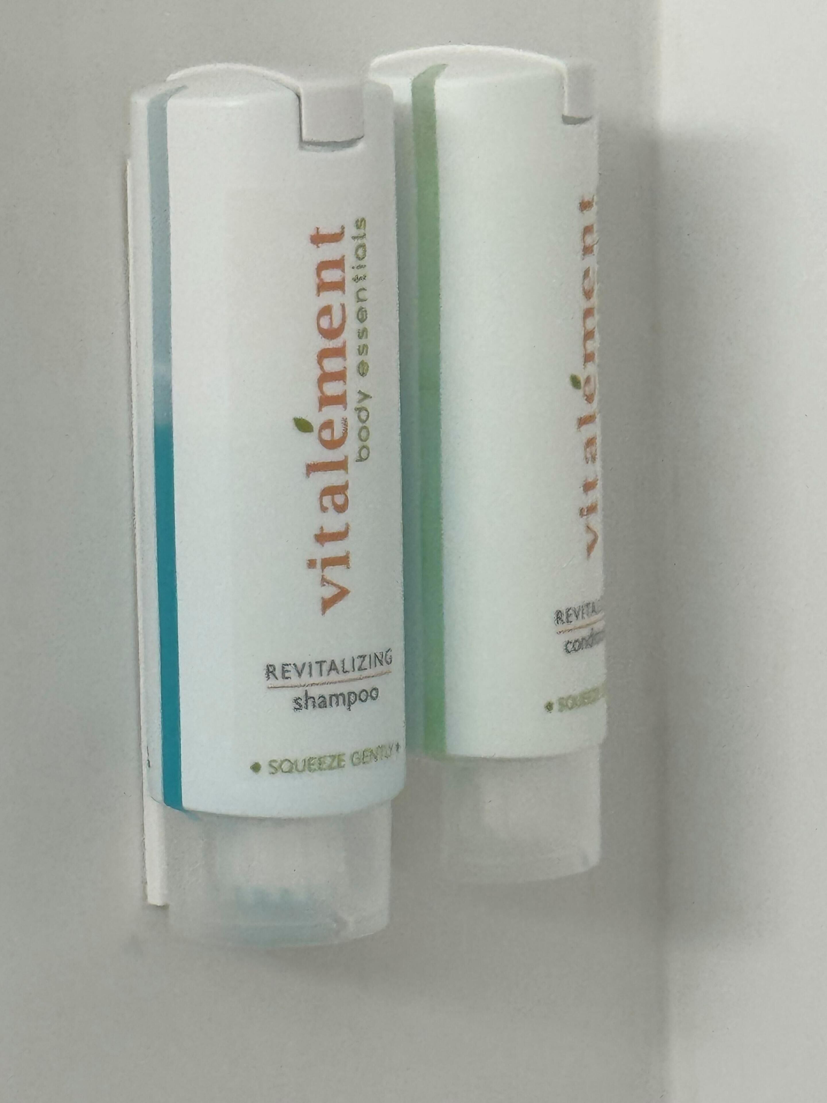 Two bottles of Vitalement Revitalizing Shampoo and Conditioner.