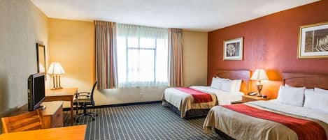 A hotel room with two beds, a desk with a chair, a television, and a window with curtains.