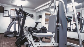 A gym with various exercise equipment including treadmills, weight machines, and dumbbells. - La Quinta Inn by Wyndham Moline Airport (Moline)