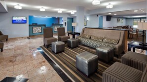 A hotel lobby with a reception desk, seating area, and a dining area. - Best Western Emporia (Emporia)