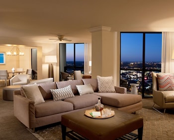 Presidential Suite, 1 Bedroom | Living area | 50-inch LCD TV with cable channels, TV, pay movies at Hilton Orlando Buena Vista Palace Disney Springs Area