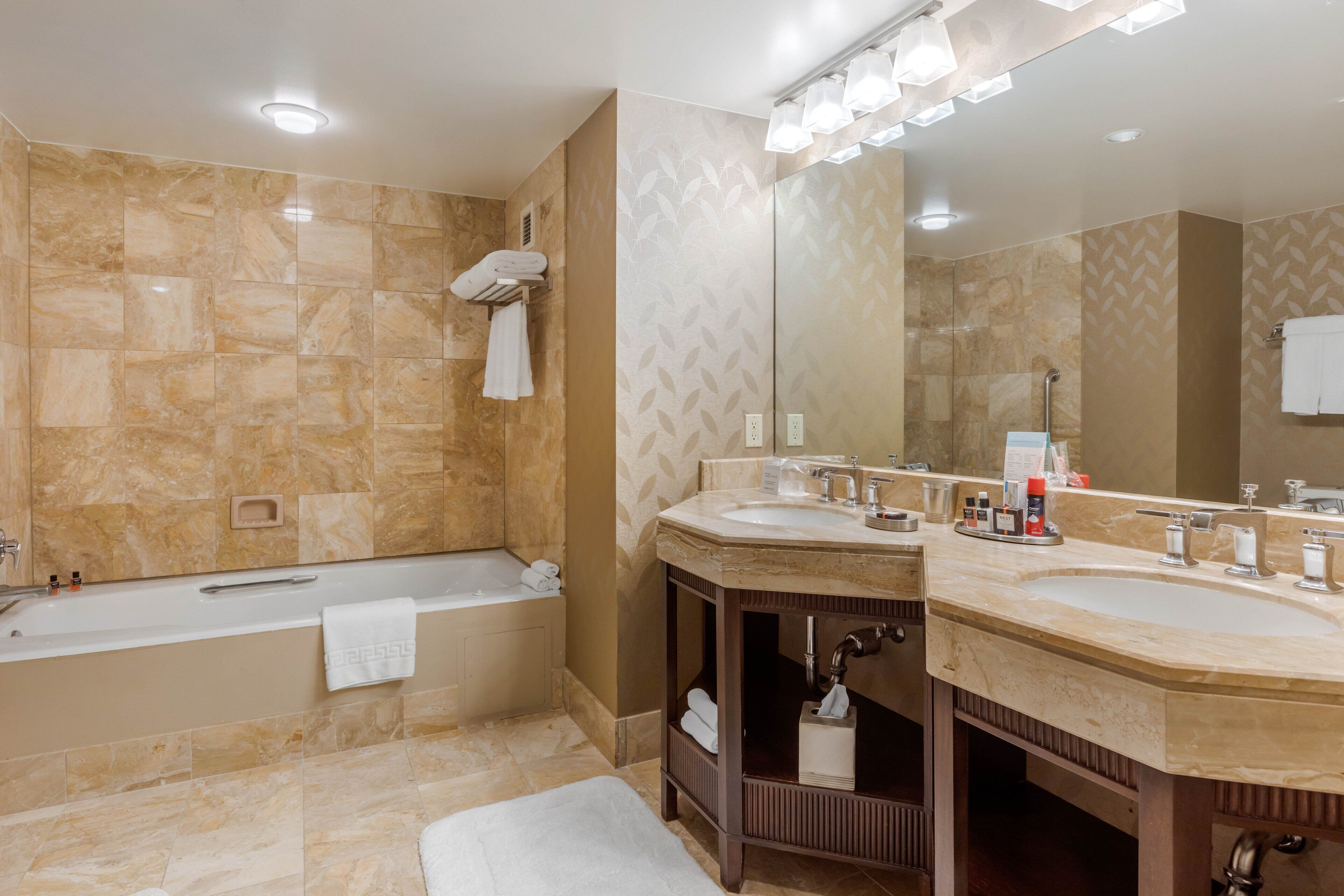 deluxe suite, 1 king bed | bathroom | combined shower/bathtub, free toiletries, hair dryer, bathrobes