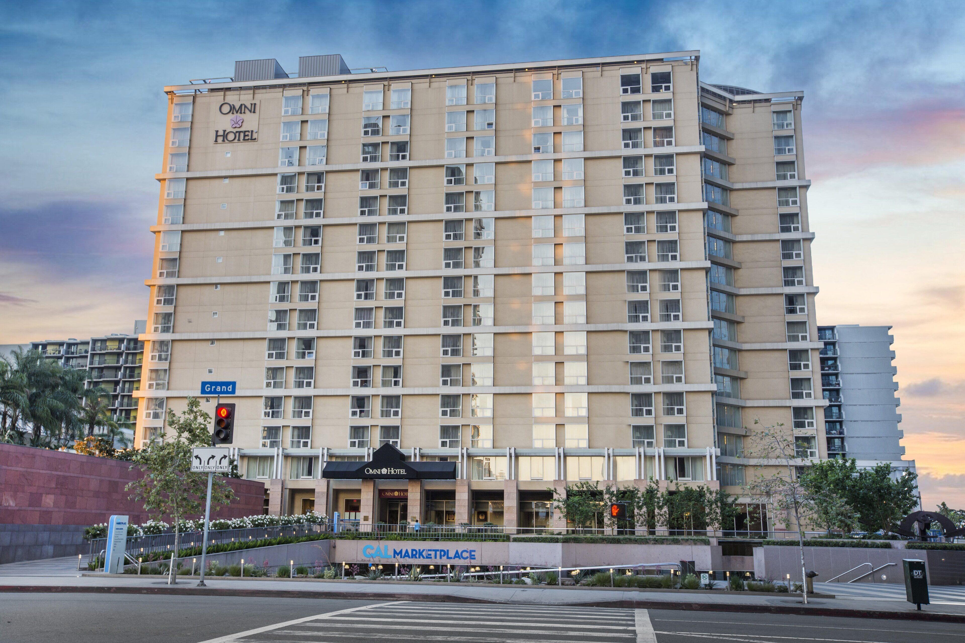 A multi-story hotel with a prominent sign for Omni Hotel and a nearby Grand Hotel.