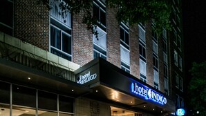 A hotel with a modern facade, large windows, and a prominent sign for 'Hotel Indigo'. - Hotel Indigo Birmingham Five Points S - UAB by IHG (Birmingham)
