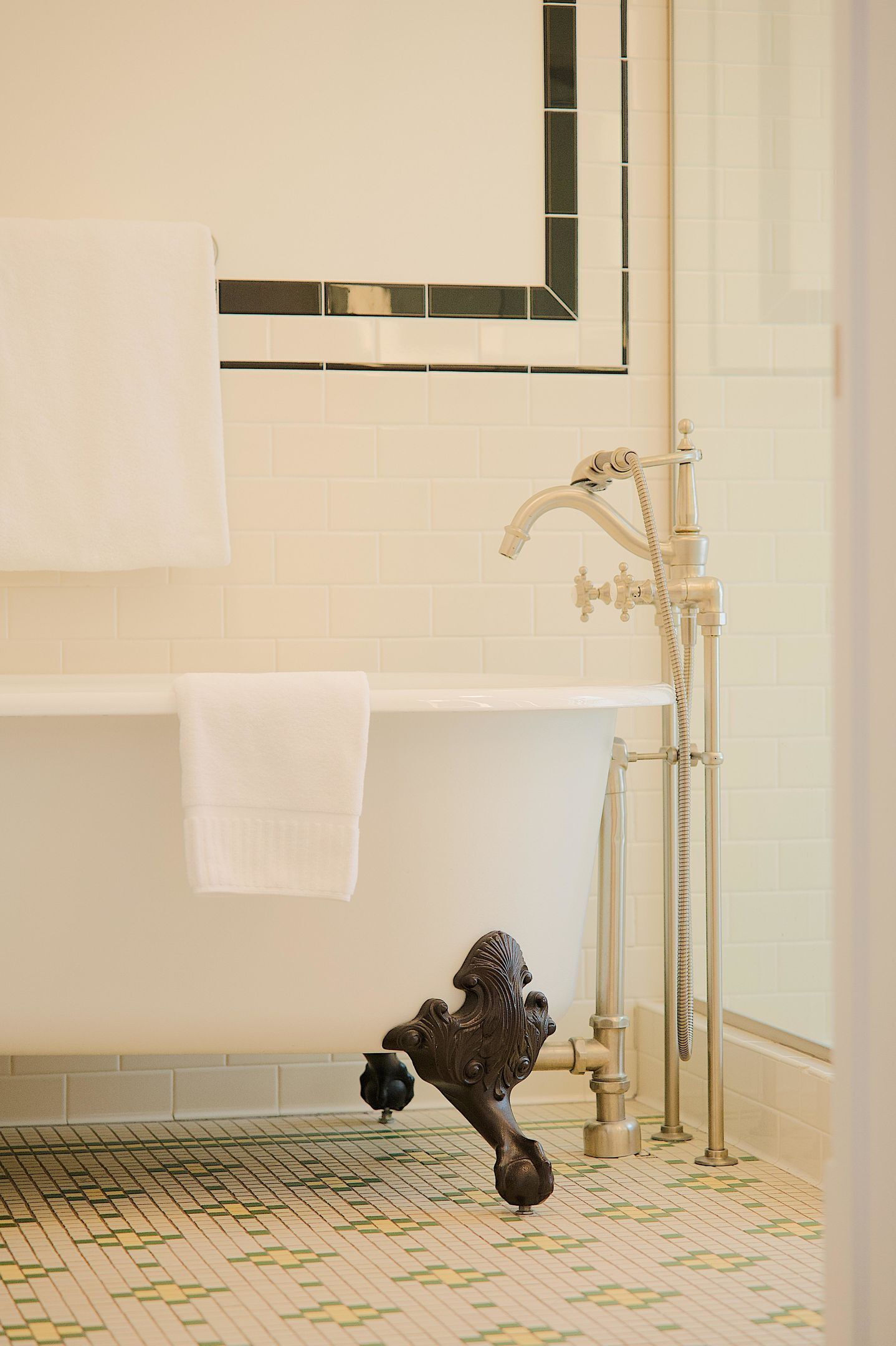 A bathroom with a bathtub, a shower, and a decorative metal fixture.