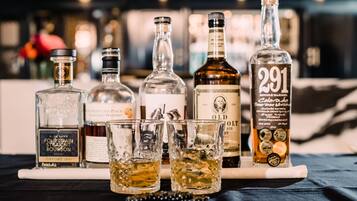 A selection of liquor bottles and glasses on a bar counter.