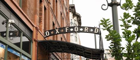 A building with a sign that reads "OXFORD ROAD HOTEL" and a street lamp.