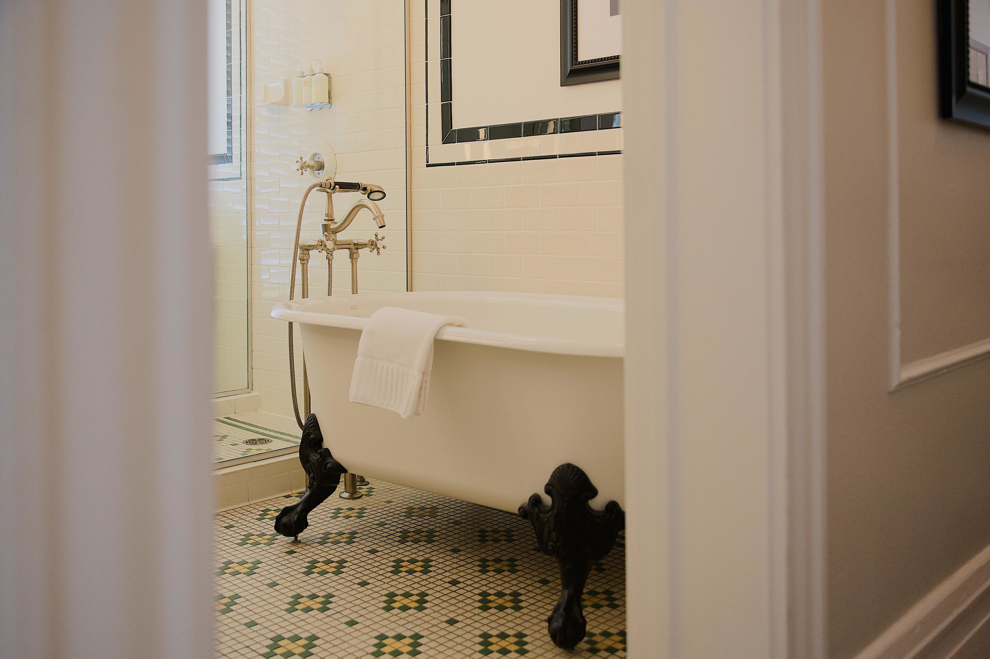 Un baño con bañera, lavamanos y espejo.