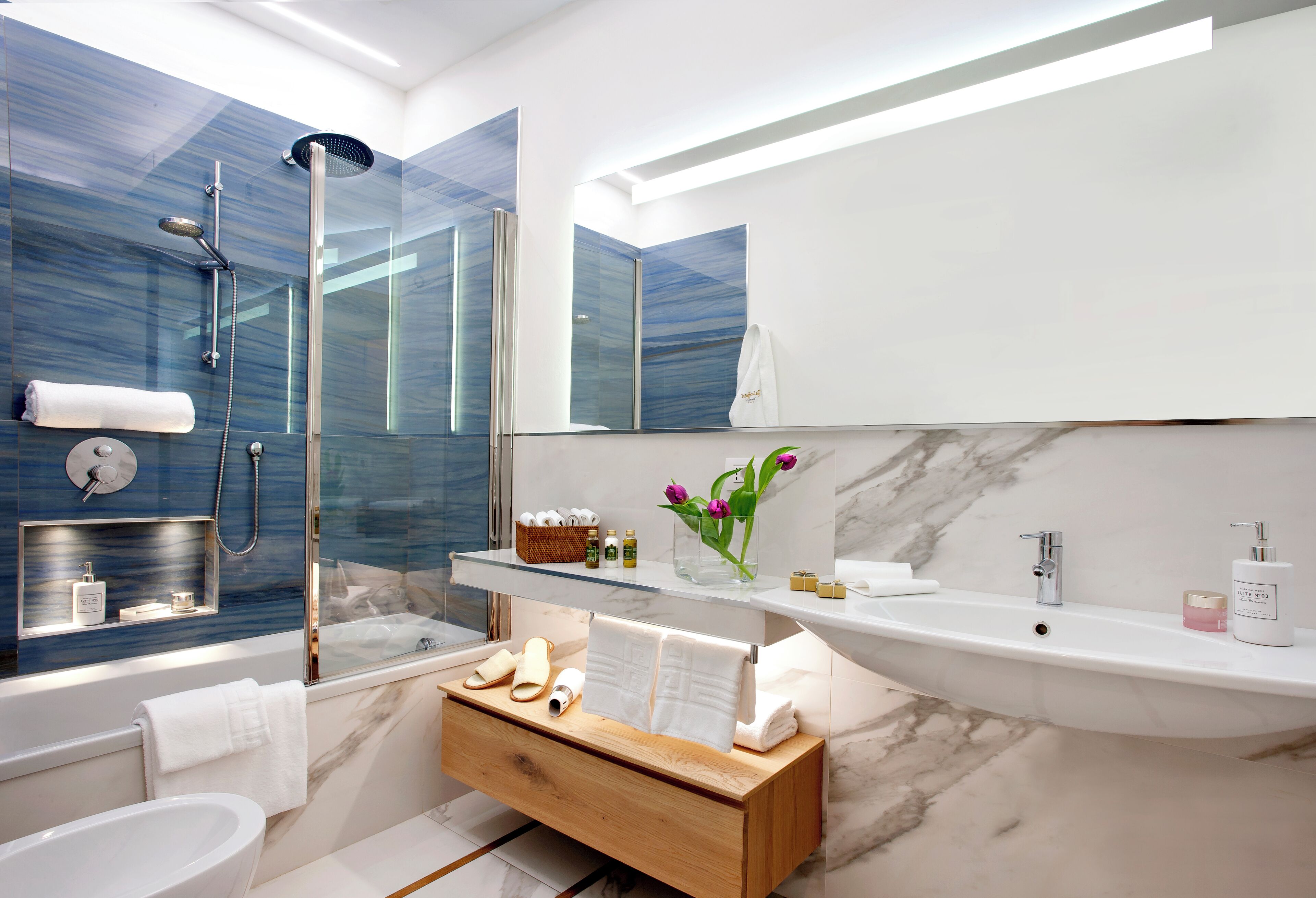 combined shower/bathtub, designer toiletries, hair dryer, slippers