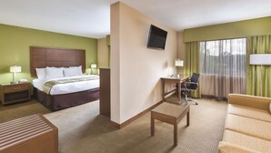 A hotel room with a bed, desk, chair, and a television on the wall. - La Quinta Inn by Wyndham Austin North (Austin)