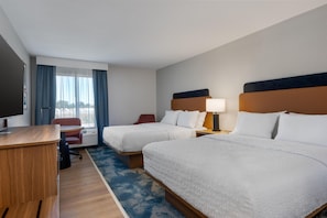 A hotel room with two beds, a desk, a chair, a TV, and a window with curtains. - Hampton Inn Owensboro South (Owensboro)