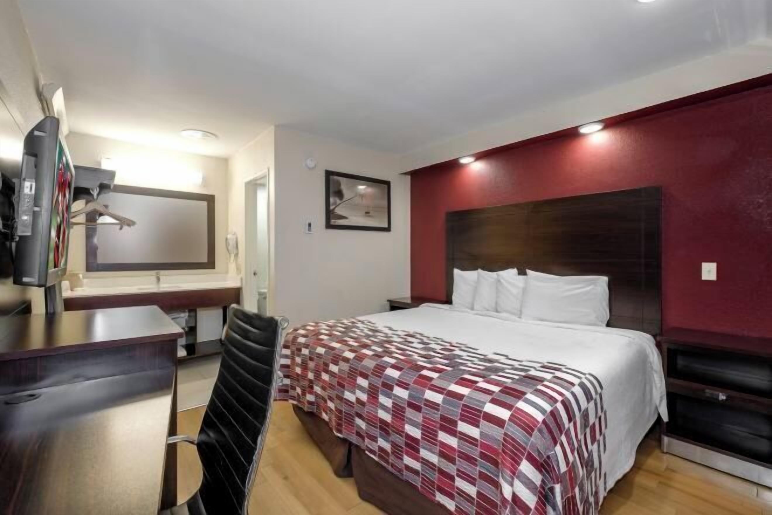 Desk, laptop workspace, blackout drapes, iron/ironing board