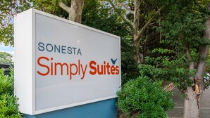 A sign for Sonesta Simply Suites. - Sonesta Simply Suites Memphis East Poplar Pike ​ (Memphis)