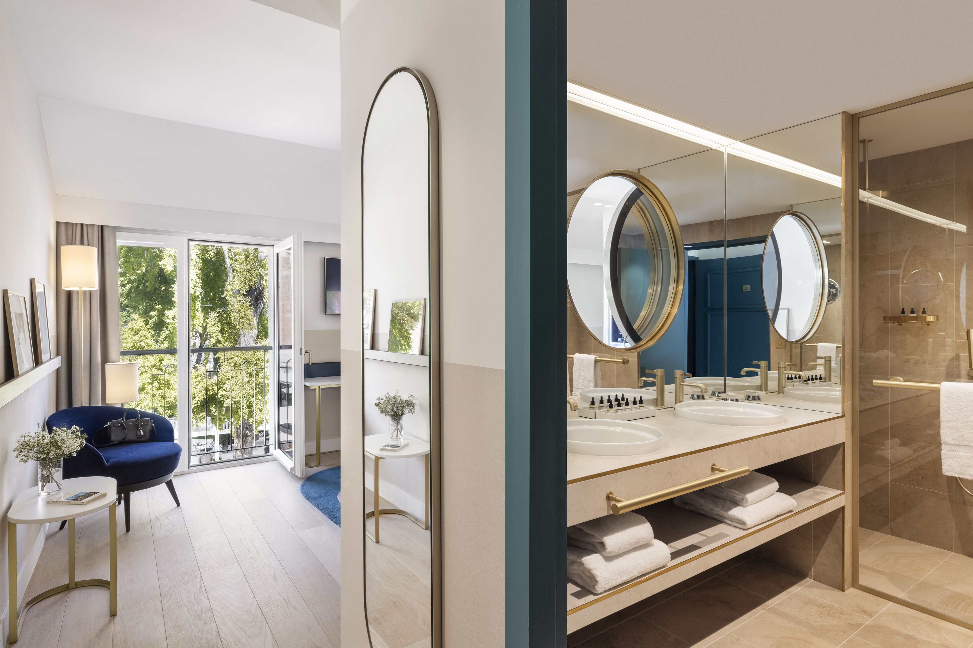 A modern bathroom with a large mirror, dual sinks, and a glass shower enclosure.