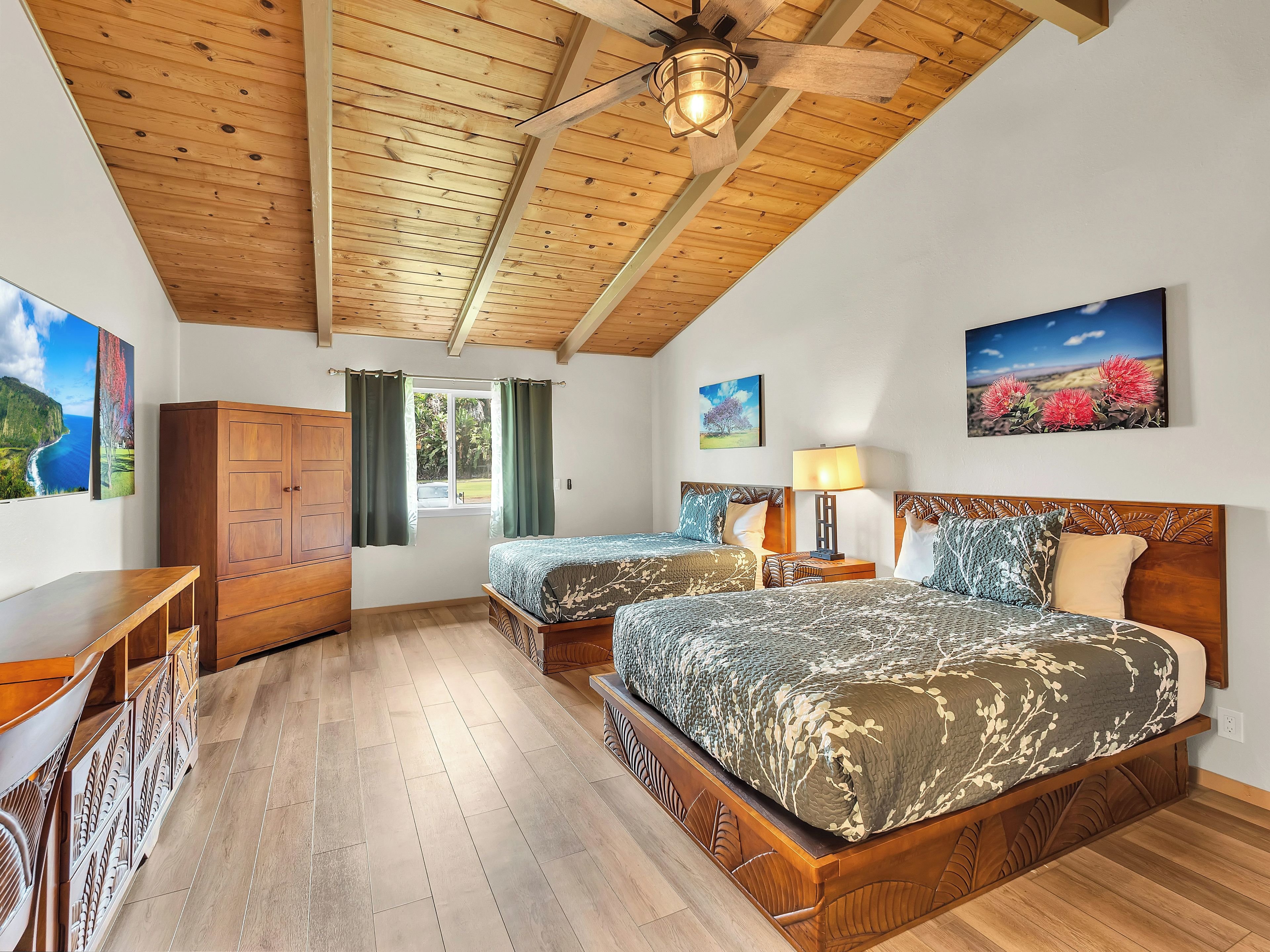A bedroom with two beds, wooden ceiling, and a window with curtains.