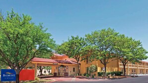 A hotel with a red-tiled roof, a covered entrance, and a sign indicating it is a Baymont by Wyndham property. - Baymont by Wyndham Lubbock - Downtown Civic Center (Lubbock)