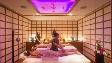 Experience tranquility in this serene spa room, featuring tatami mat flooring and shoji screens, with two massage tables and a soothing ambiance.