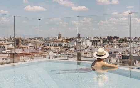 A rooftop pool with a cityscape view.