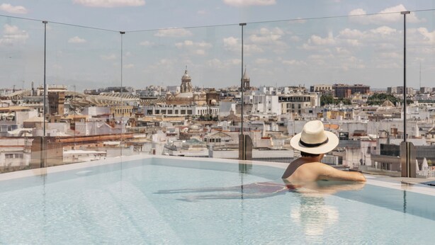 A rooftop pool with a cityscape view.