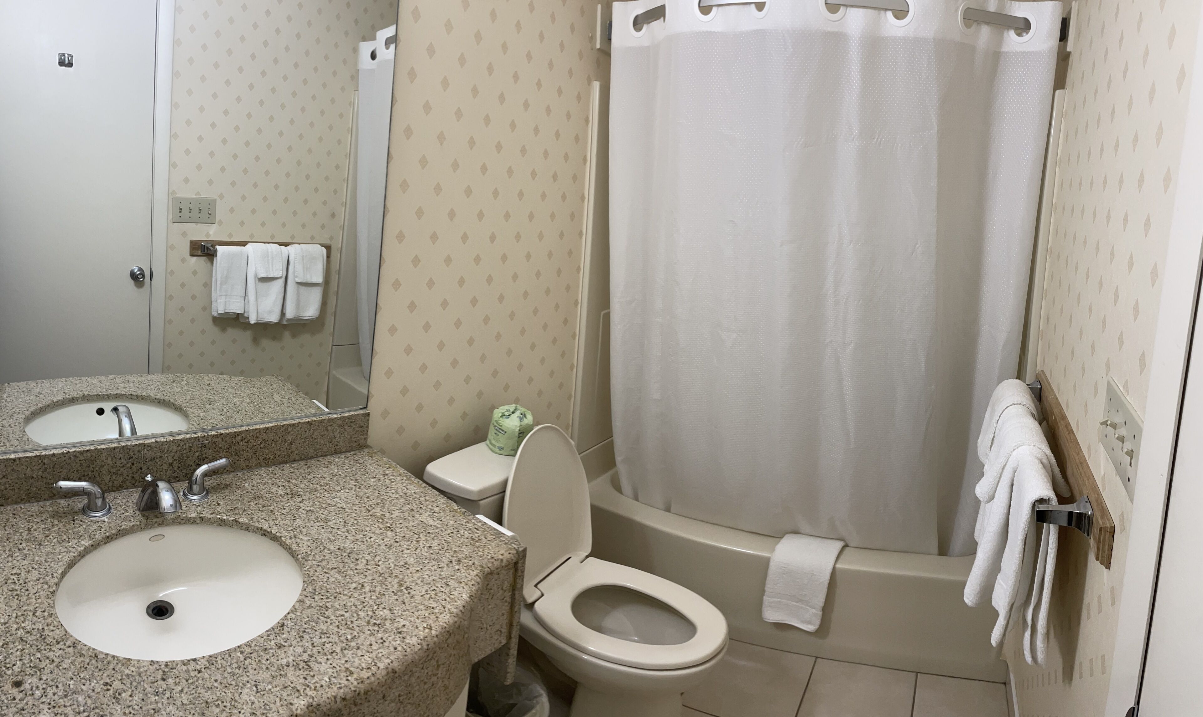 A bathroom with a sink, toilet, and bathtub.