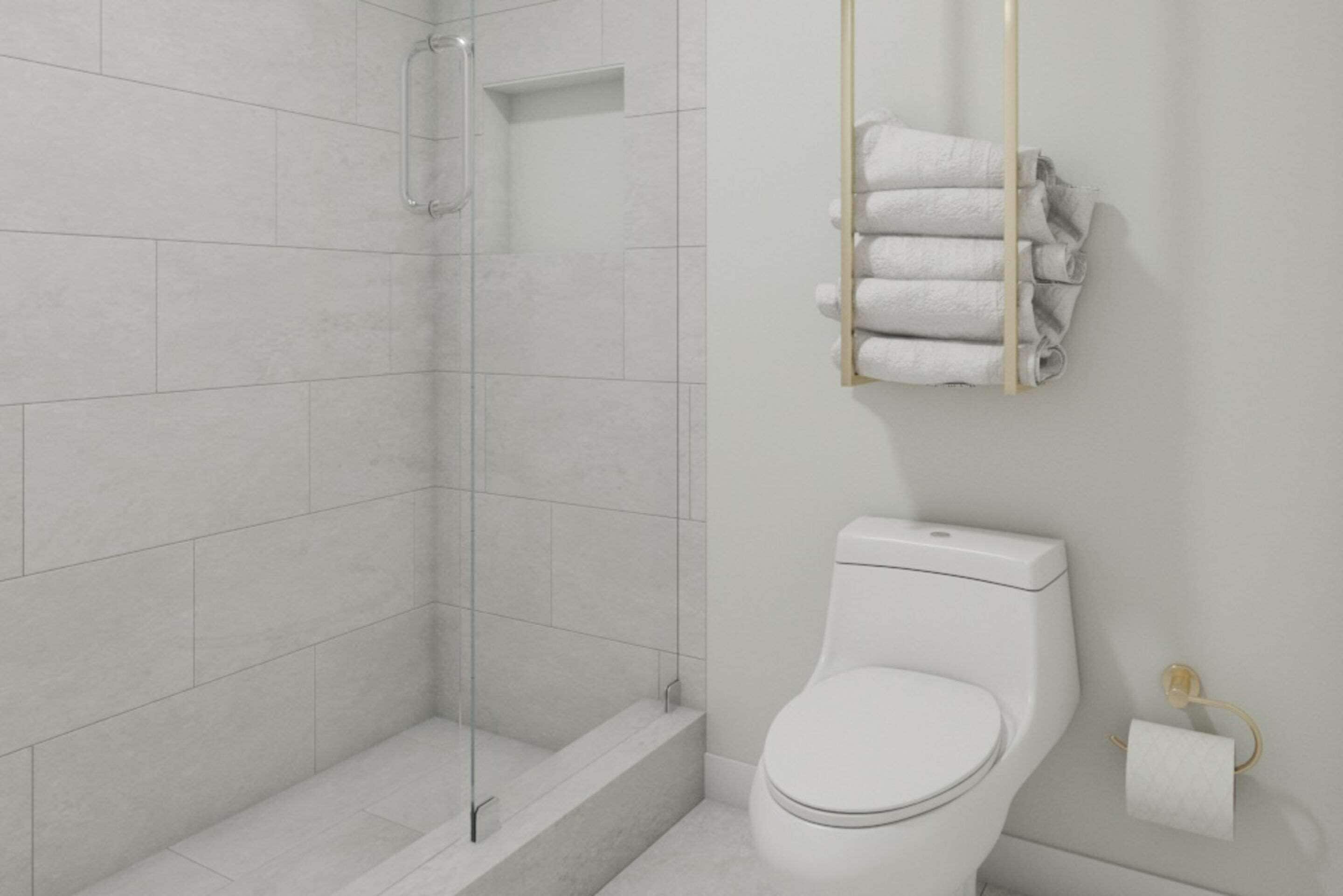 A modern bathroom with a glass shower enclosure, a toilet, and a towel rack with folded towels.