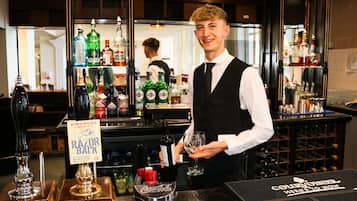 A bar area with a variety of bottles and a sign reading "Razor Back".
