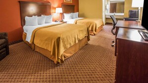 A hotel room with two beds, a desk, a chair, a TV, and a bathroom visible through an open door. - Quality Inn Gaffney I-85 (Gaffney)