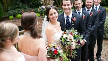 Couples can exchange vows in a serene garden setting surrounded by lush greenery and vibrant flowers.