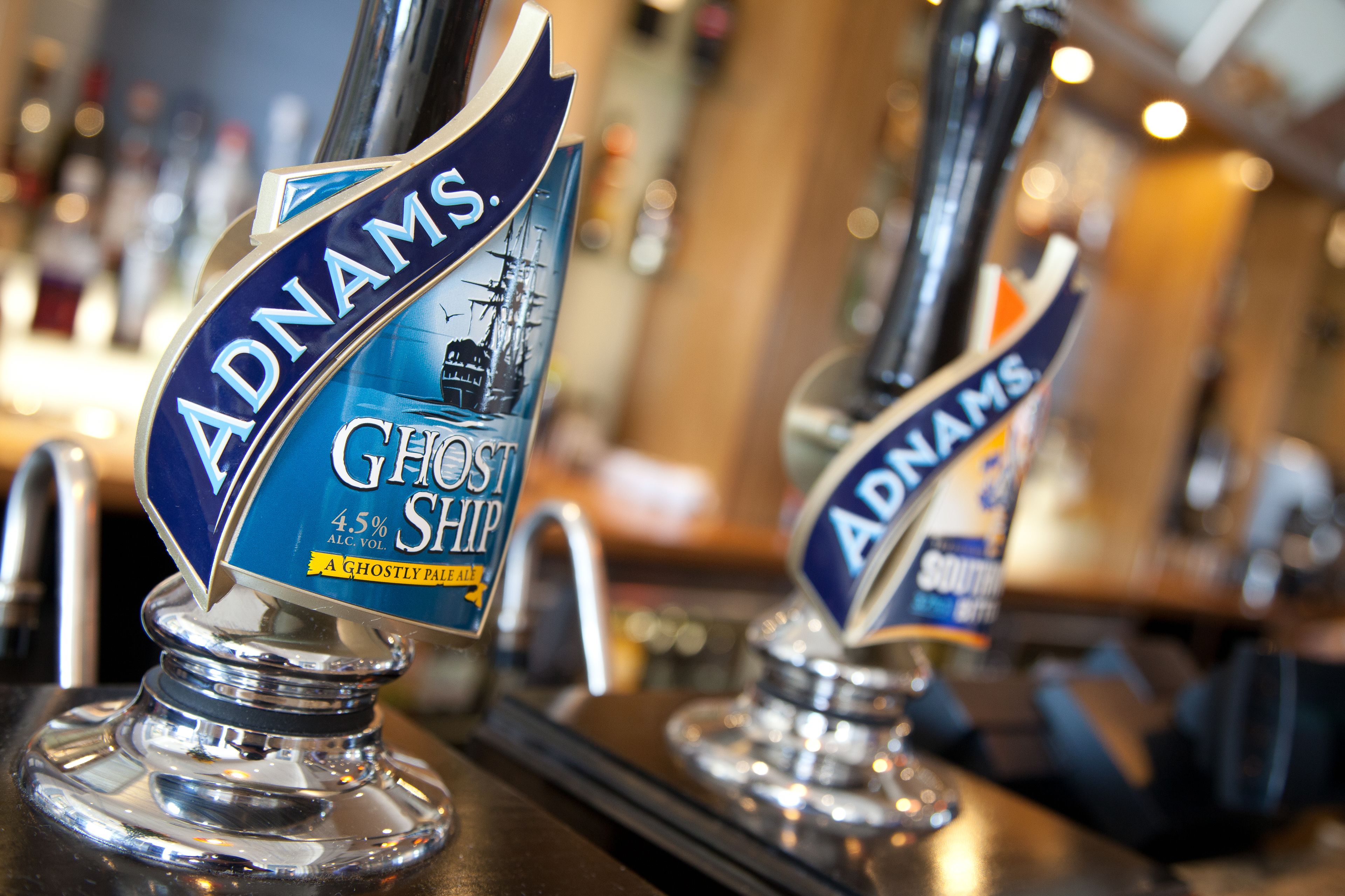 A bar with taps labeled 'Adnams Ghost Ship' and 'Adnams Southwold Bitter'.