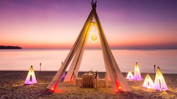 On the beach, white sand, beach towels, beach massages