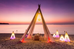On the beach, white sand, beach towels, beach massages