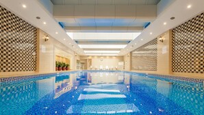 A large indoor swimming pool with checkered tile patterns on the walls and a clear view of the ceiling. - Crowne Plaza Hotel Shanghai by IHG (Shanghai)