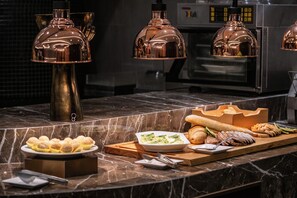 A buffet setup with various food items and a coffee machine in the background. - Crowne Plaza Hotel Shanghai by IHG (Shanghai)