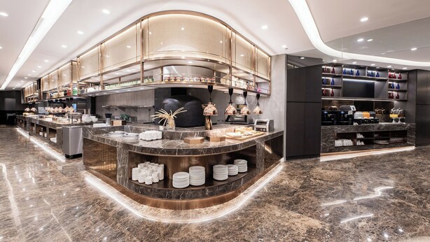 A modern kitchen with marble countertops, stainless steel appliances, and a curved ceiling design. - Crowne Plaza Hotel Shanghai by IHG (Shanghai)