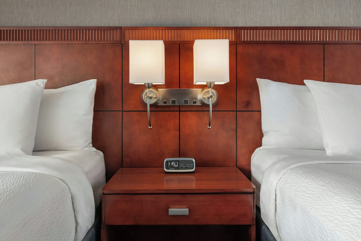 Hypo-allergenic bedding, desk, laptop workspace, blackout drapes