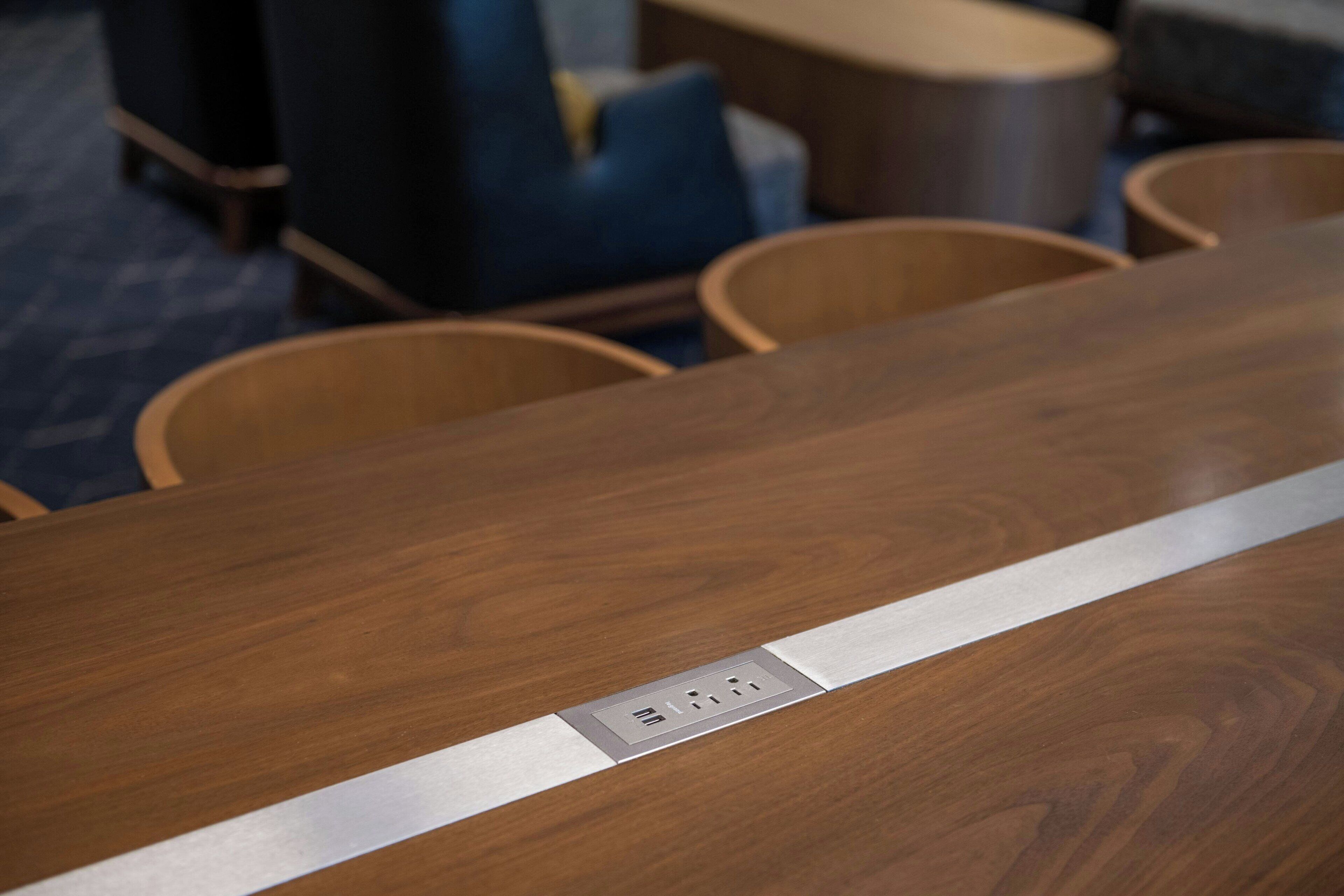 A conference table with a built-in power strip.