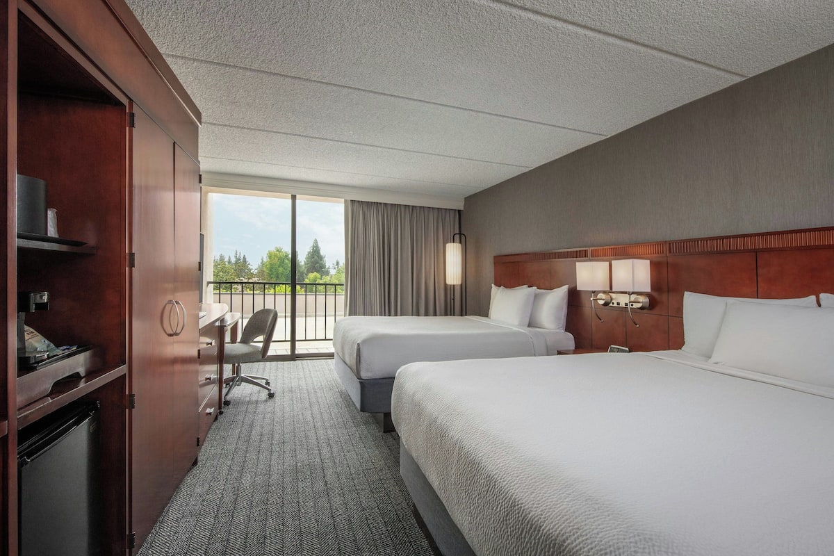 Hypo-allergenic bedding, desk, laptop workspace, blackout drapes