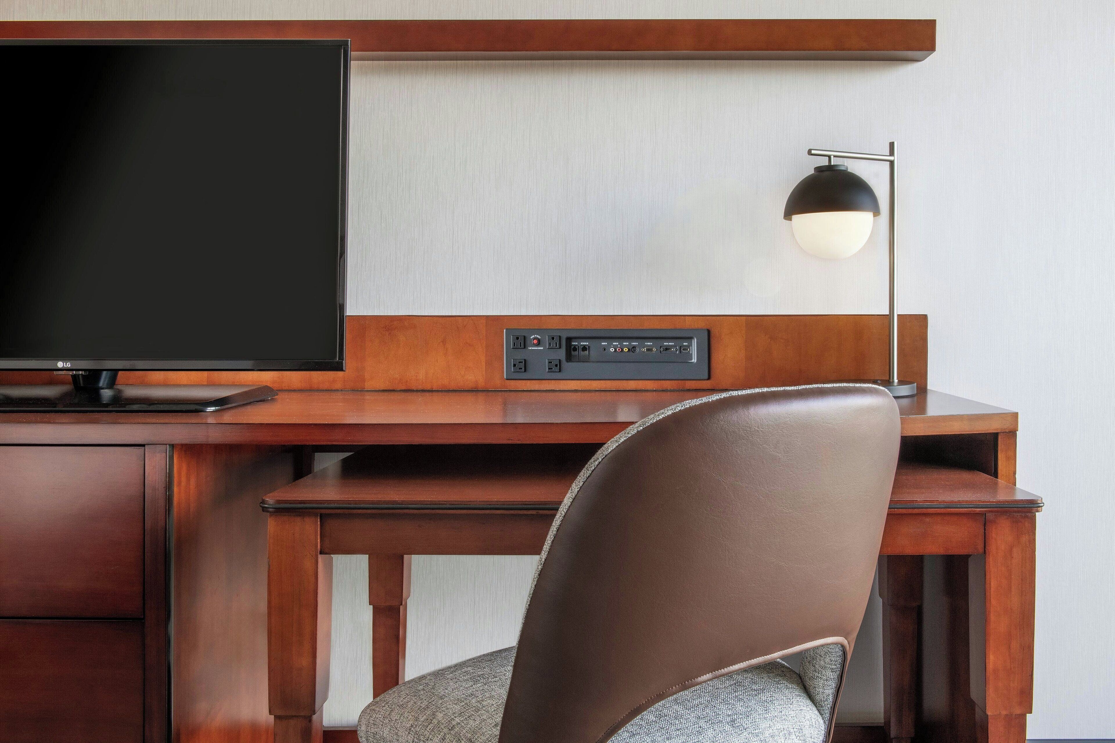 hypo-allergenic bedding, desk, laptop workspace, blackout curtains