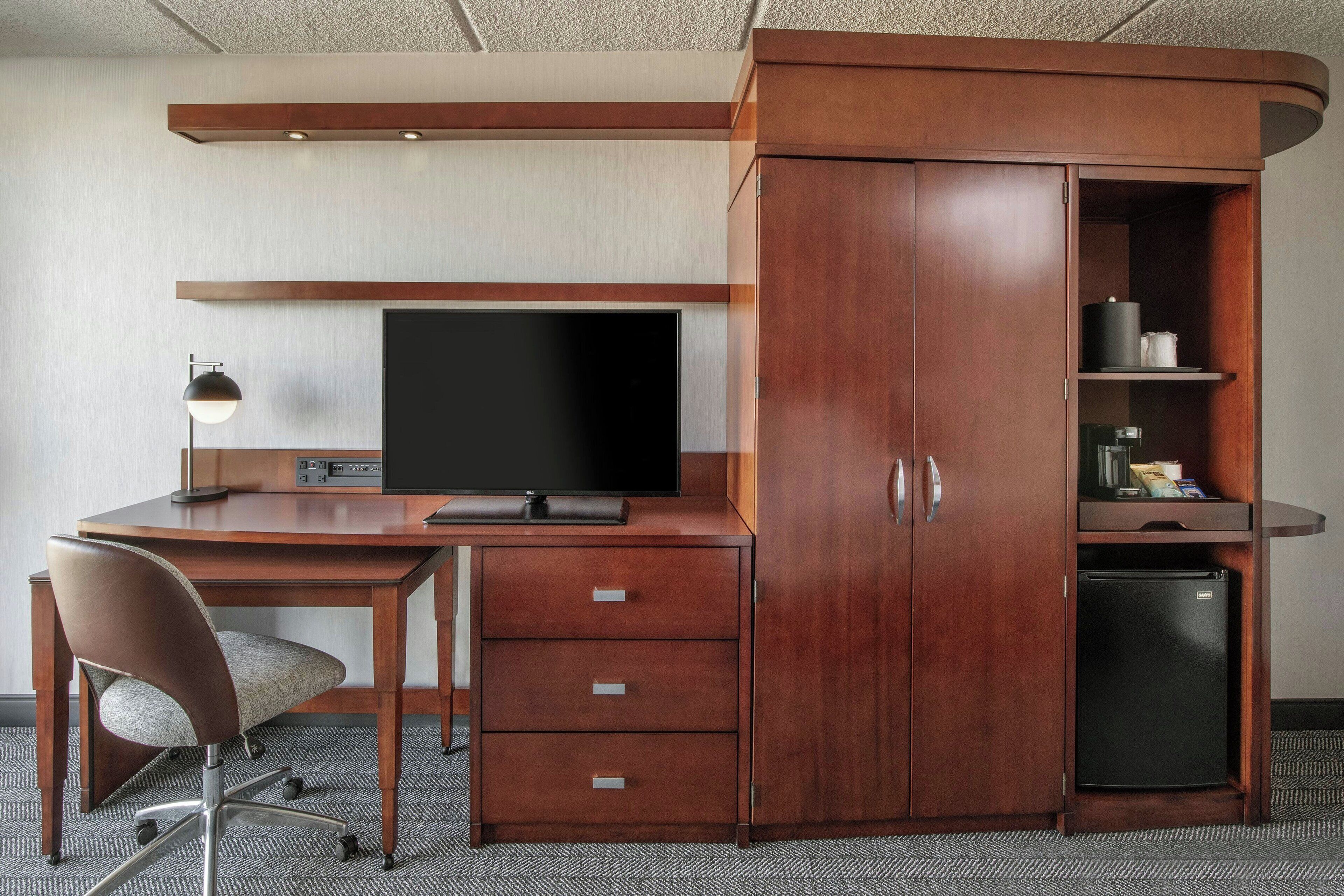 hypo-allergenic bedding, desk, laptop workspace, blackout curtains