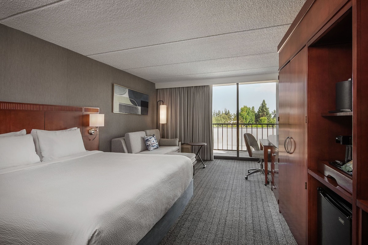 hypo-allergenic bedding, desk, laptop workspace, blackout curtains