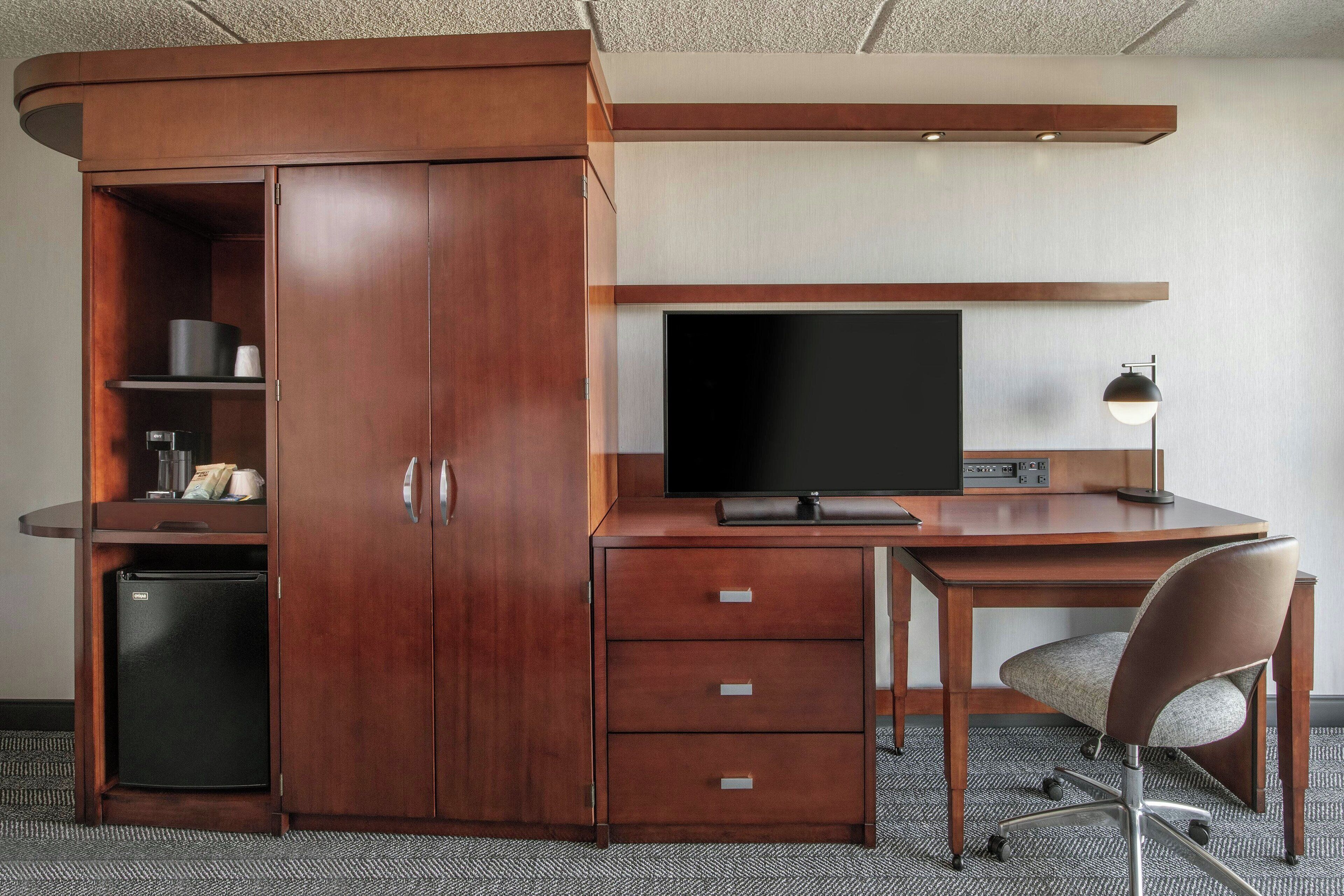 hypo-allergenic bedding, desk, laptop workspace, blackout curtains