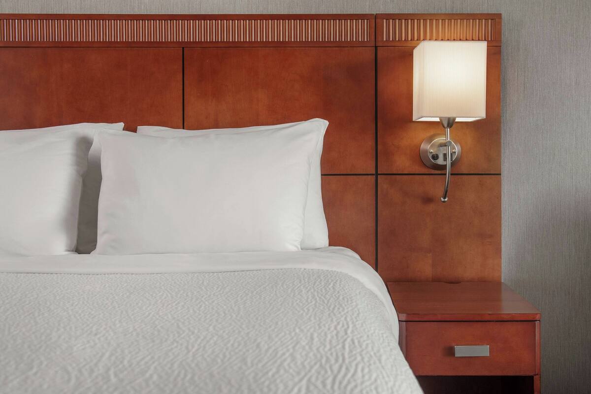 hypo-allergenic bedding, desk, laptop workspace, blackout curtains