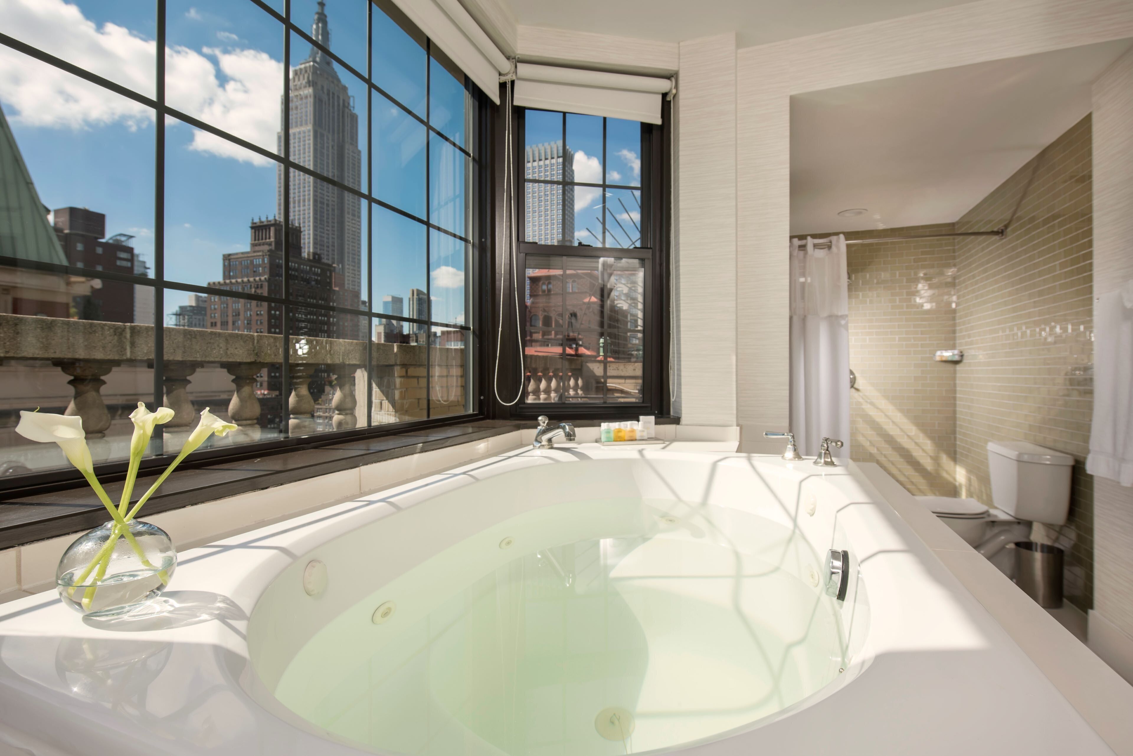 combined shower/bathtub, designer toiletries, hair dryer, bathrobes