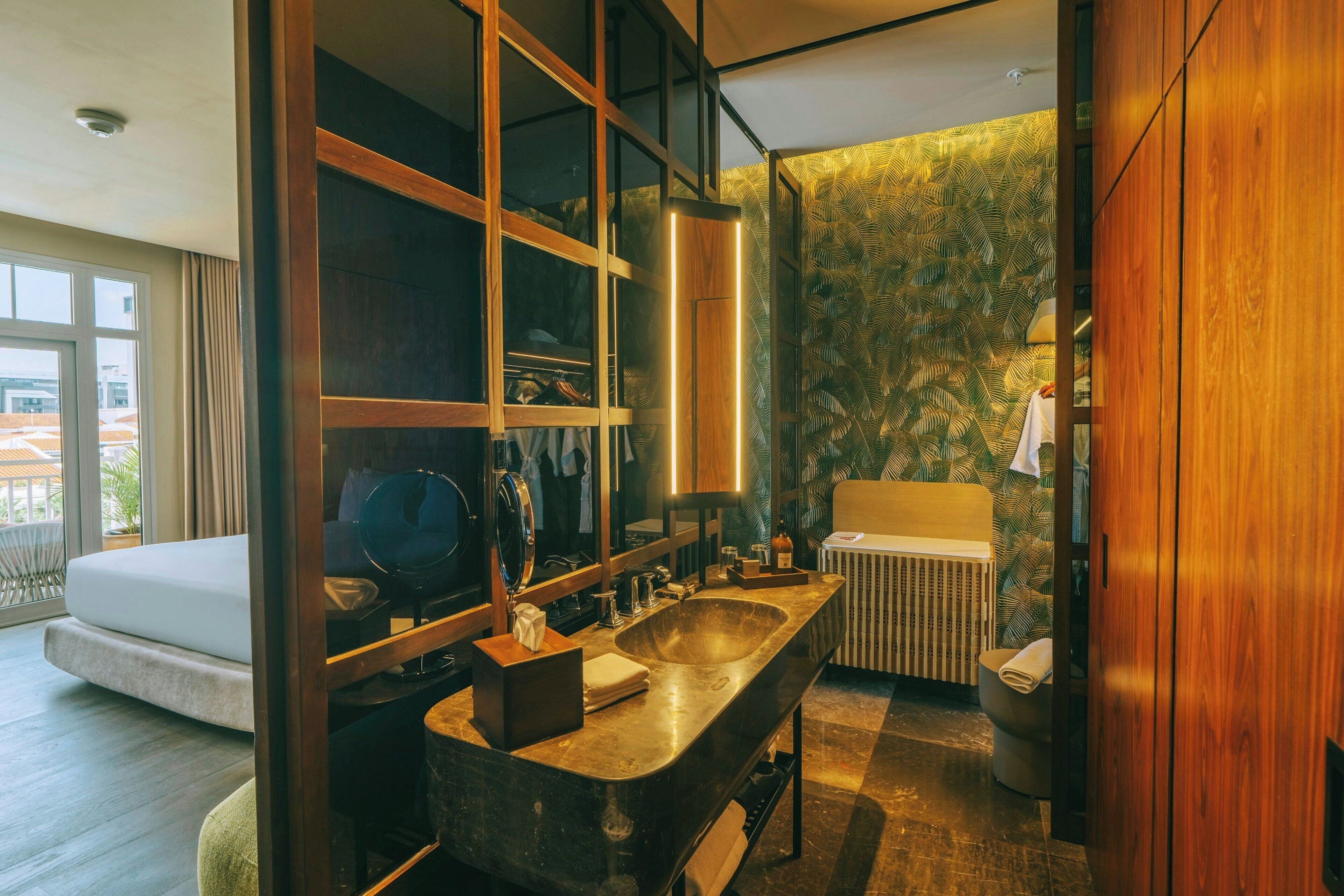 A modern bathroom with a large freestanding bathtub, a vanity with a mirror, and a radiator.