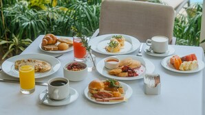 A dining table with breakfast items and a pool view. - Los Tajibos, Santa Cruz de la Sierra, a Tribute Portfolio Hotel (Santa Cruz)