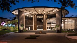A modern hotel entrance with a curved canopy, large columns, and a well-lit facade. - Los Tajibos, Santa Cruz de la Sierra, a Tribute Portfolio Hotel (Santa Cruz)