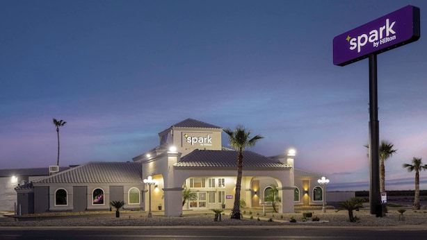 A hotel named 'Spark by Hilton' with a modern design, featuring a prominent sign, a well-lit facade, and a parking lot in front. - Spark by Hilton Santa Nella on I-5 (Gustine)