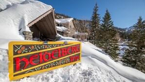 A snow-covered mountain area with a sign for Heidelberg Inn. - Heidelberg Inn (June Lake)